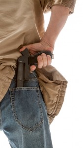 man holding gun behind back