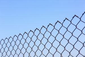 chain link fencing in front of a blue sky