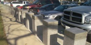 A row of concrete security bollards.