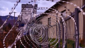 A coil of razor wire atop a fence